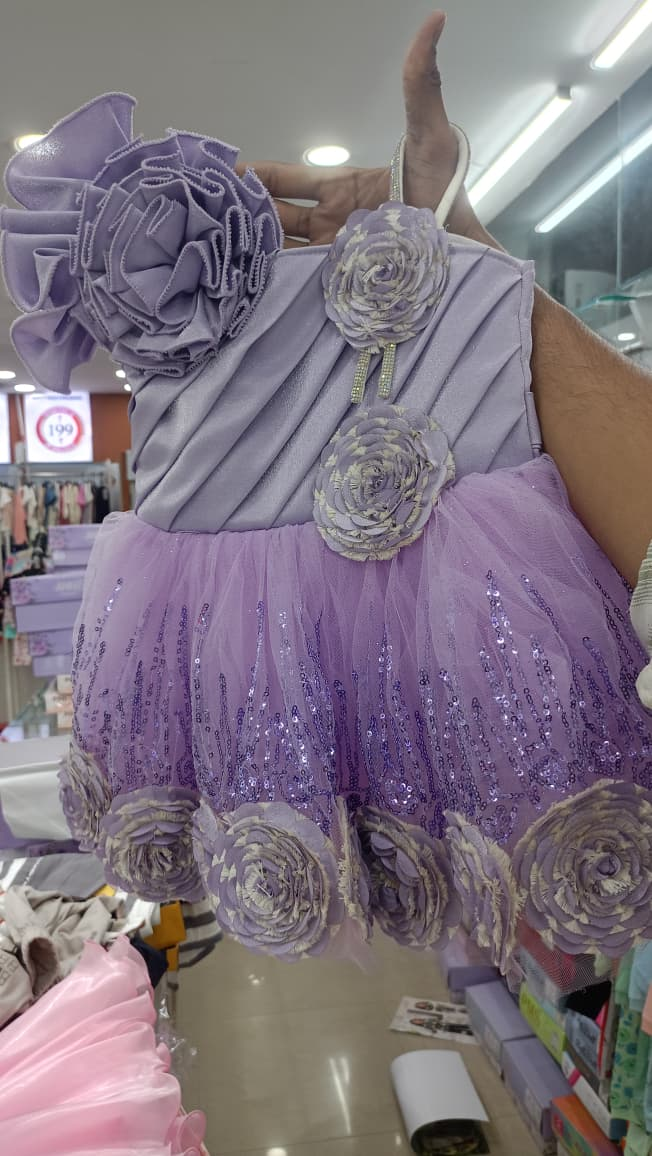 Lavender girls party dress with layered ruffles, floral appliqués, and sparkling accents