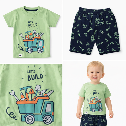 Children's outfit with green t-shirt and navy shorts featuring construction-themed designs.