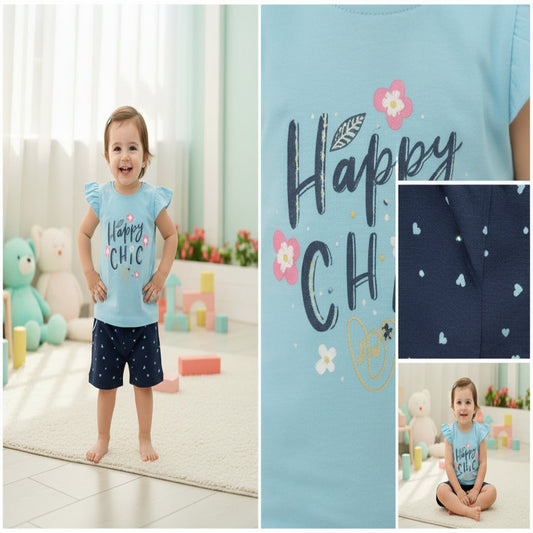 Children's outfit with blue top and navy shorts on a white background