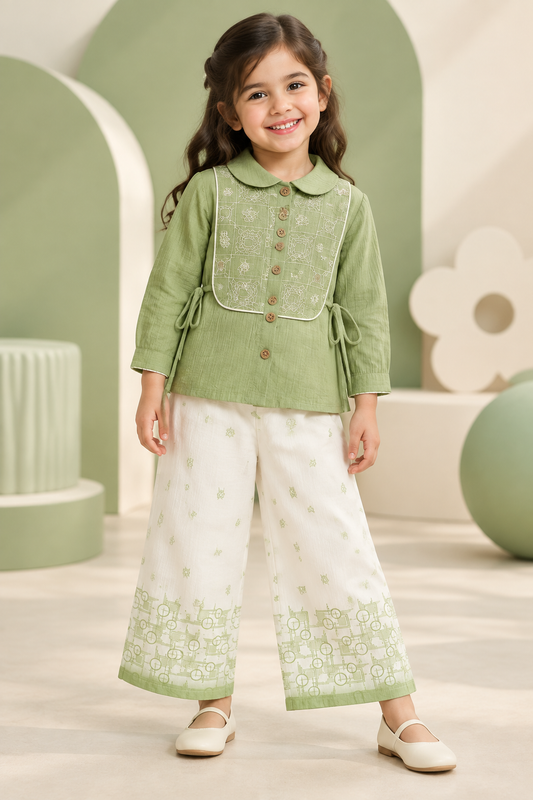 Girl wearing sage-green embroidered top and ivory wide-leg pants