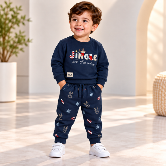 Boy wearing a navy Jingle All the Way sweatshirt and Christmas-print joggers