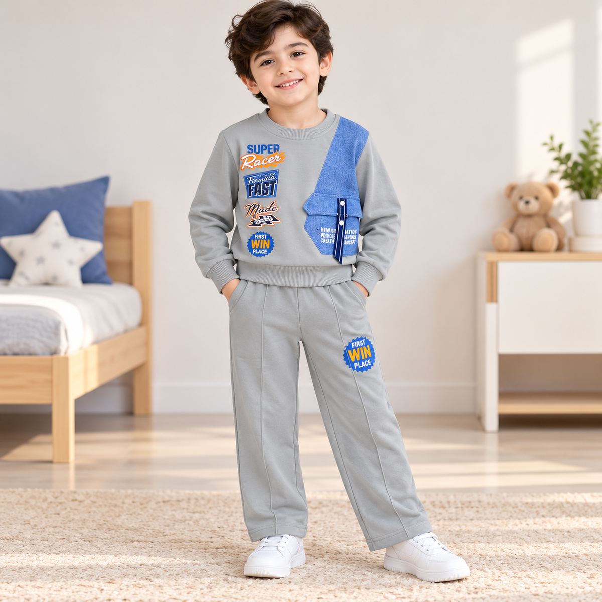 Boy wearing a grey Super Racer graphic sweatshirt with a blue panel and matching grey pants