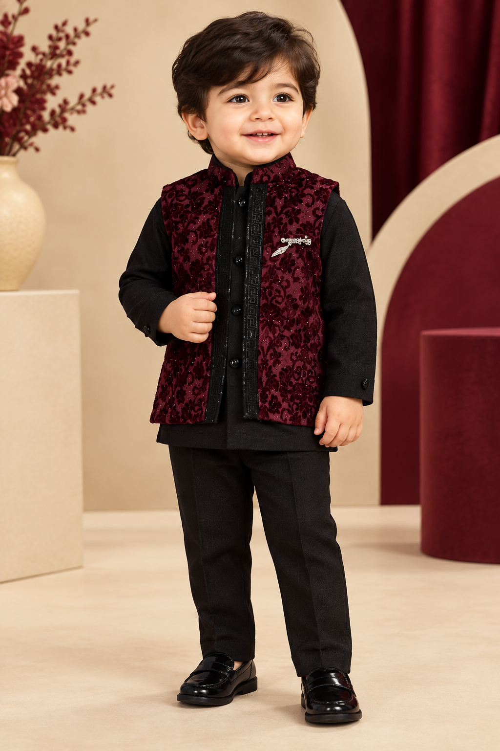 Toddler wearing wine patterned waistcoat over black top and black pants