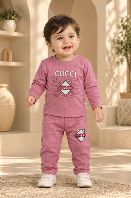 Baby boy wearing dusty-pink graphic top and matching pants