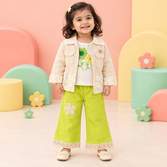 Toddler girl wearing floral top, cream jacket and lime pants in a playful studio