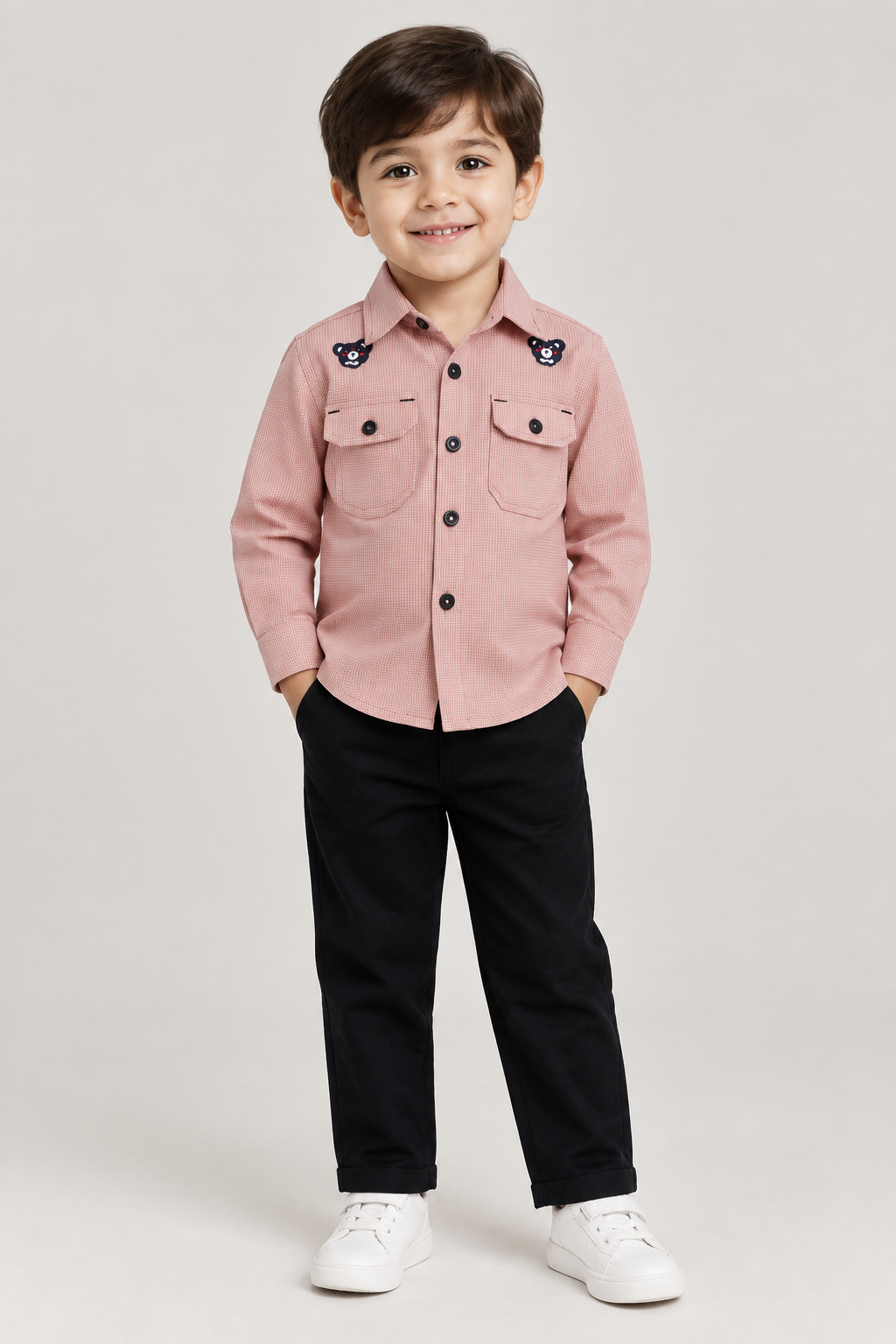 Child model wearing pink button-front bear-detail shirt with black pants