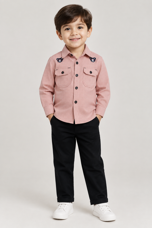 Child model wearing pink button-front bear-detail shirt with black pants