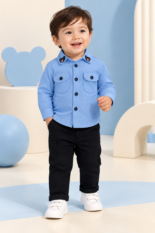 Toddler wearing blue bear-detail shirt and black pants