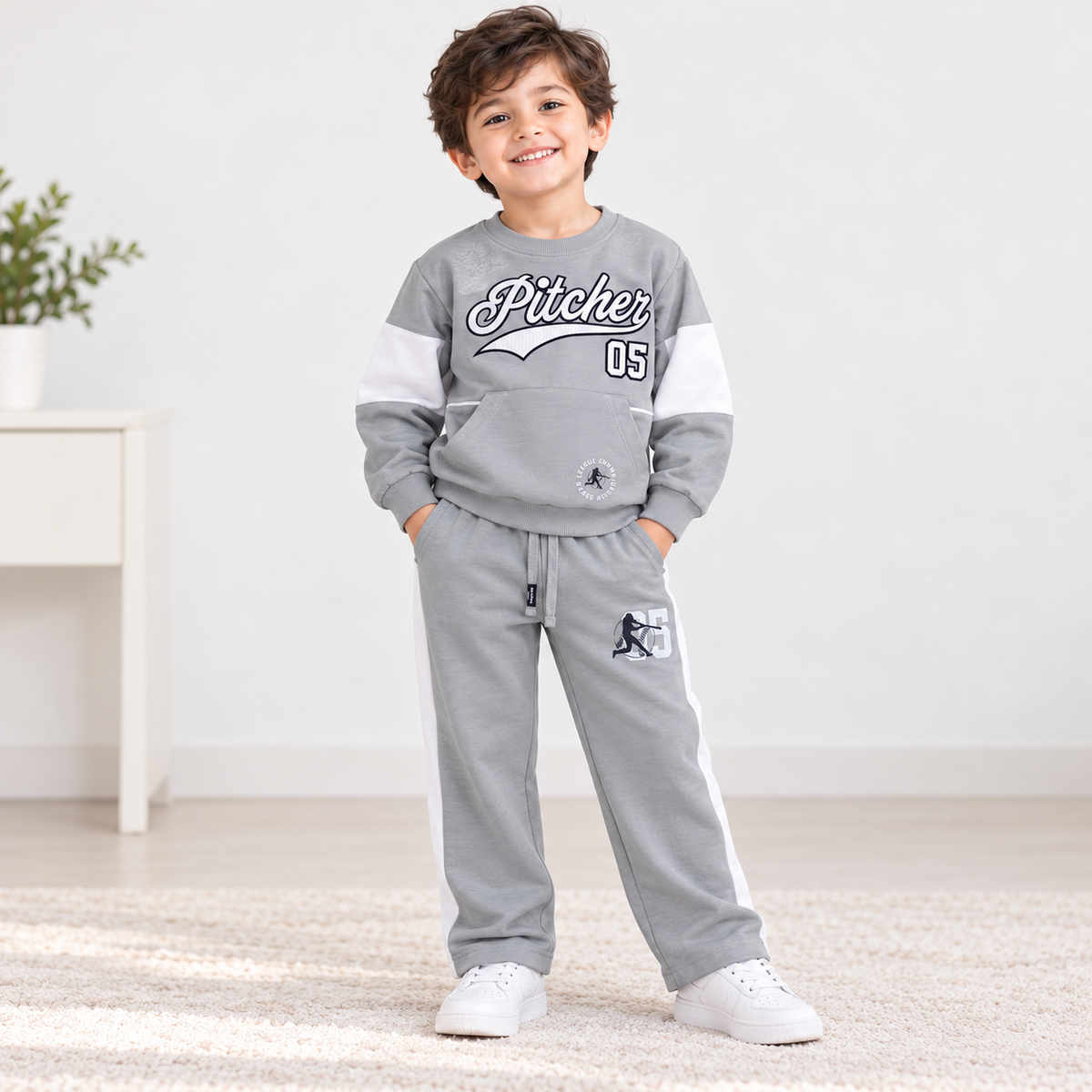 Boy wearing a grey Pitcher graphic sweatshirt with white sleeve panels and matching grey pants with white side stripes
